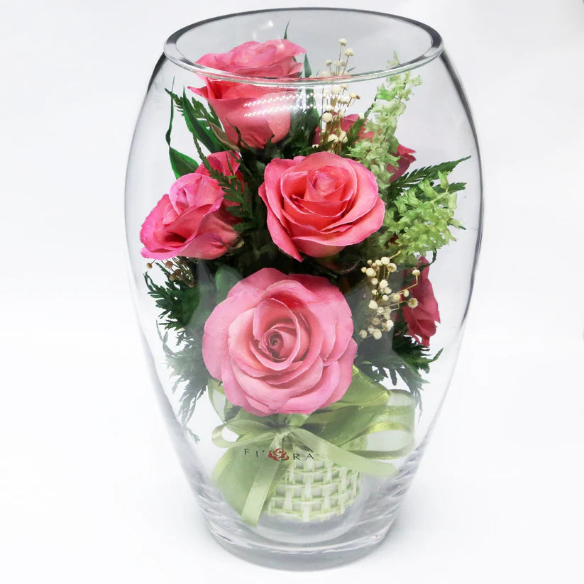 Seven Vibrant Rosy Charm Pink Roses in a Stylish Round Glass Vase