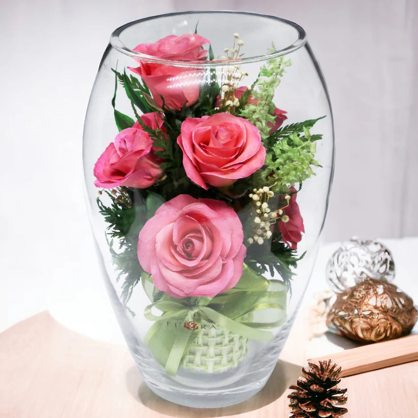 Seven Vibrant Rosy Charm Pink Roses in a Stylish Round Glass Vase