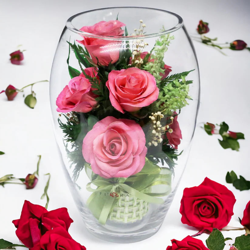 Seven Vibrant Rosy Charm Pink Roses in a Stylish Round Glass Vase