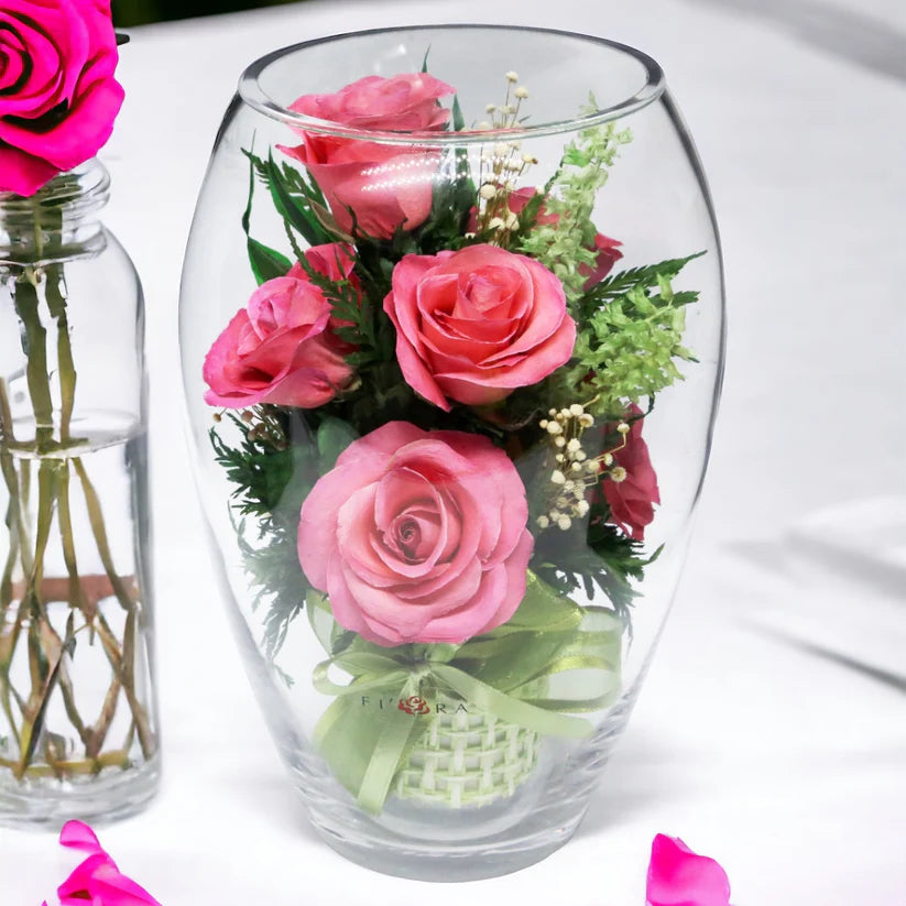 Seven Vibrant Rosy Charm Pink Roses in a Stylish Round Glass Vase